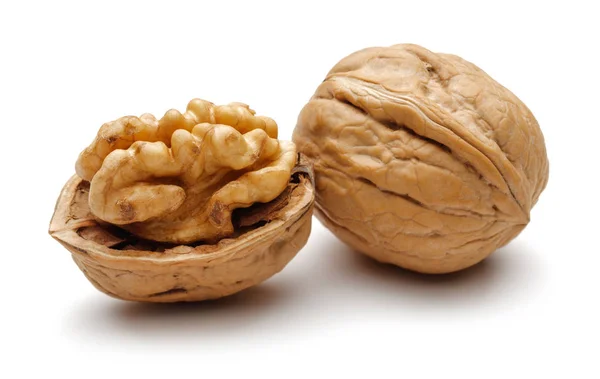 Whole and broken walnuts isolated on white — 스톡 사진