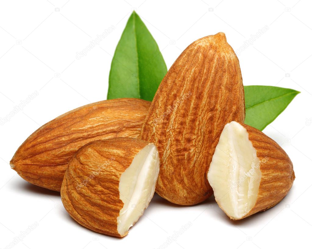 Group of almonds with leaves isolated on white