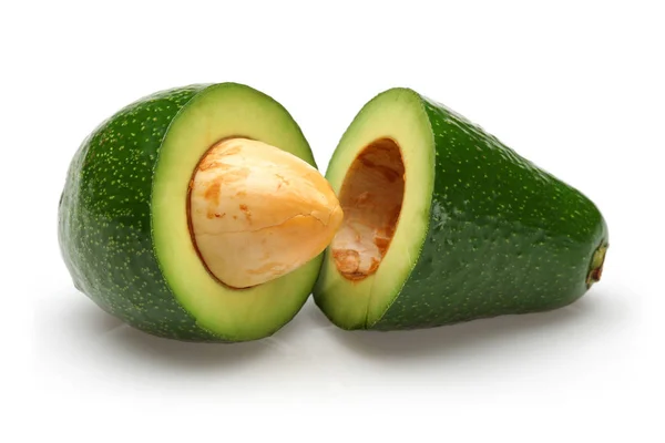 Due avocado mezzo verde con semi isolati — Foto Stock