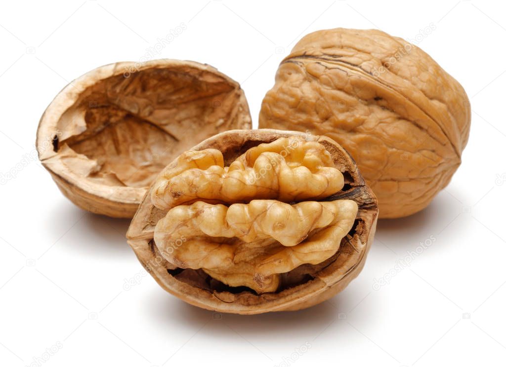 Whole and cracked walnuts isolated on white