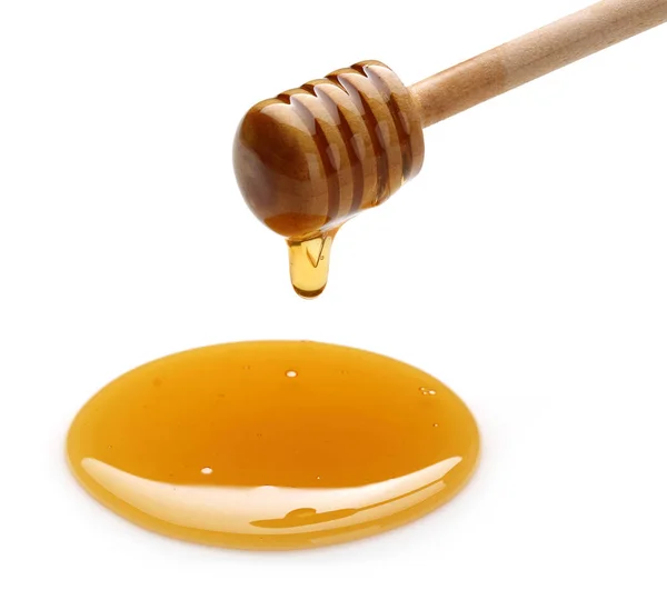 Miel goteando de la cacerola aislada en blanco —  Fotos de Stock