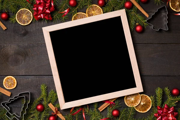 Clear black  felt letter board flatlay on dark rustic wood table with Christmas decoration and fir tree boarder. Top view with free text copy space