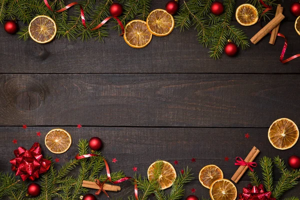 Dark rustic wood table flatlay - Christmas background with  decoration and fir branch  frame. Top view with free space for copy text