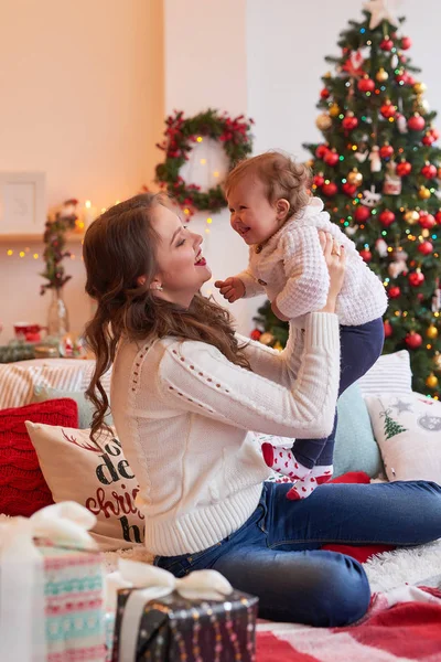 family photo session for the new year mothers and daughters in white sweaters