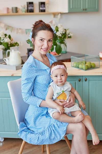 young mother and daughter cook in the kitchen