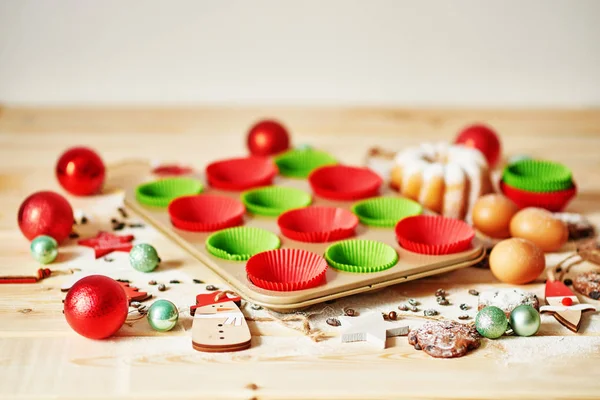 cupcake baking tin with Christmas decoration on the table