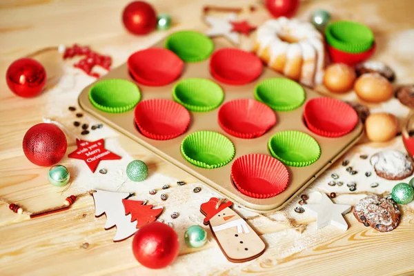 cupcake baking tin with Christmas decoration on the table