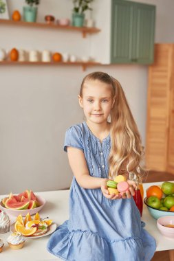 The girl eats fruit pineapple, watermelon, apples and drinks drinks from chia. Healthy food in the children's menu