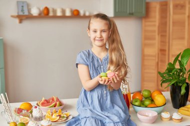 The girl eats fruit pineapple, watermelon, apples and drinks drinks from chia. Healthy food in the children's menu