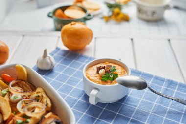 Mavi Masa örtüsü üzerinde krem balkabağı çorbası