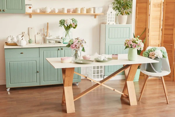 bright kitchen in the style of Provence, on the table dishes and a bouquet of flowers in a vase