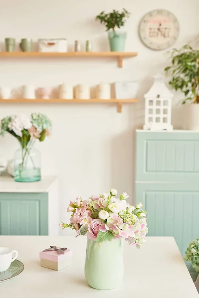 bright kitchen in the style of Provence, on the table dishes and a bouquet of flowers in a vase