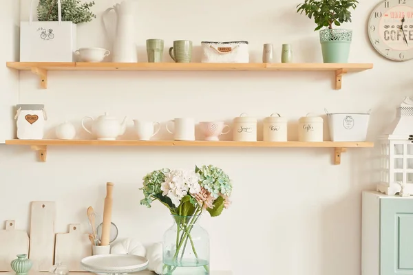 bright kitchen in the style of Provence, on the table dishes and a bouquet of flowers in a vase