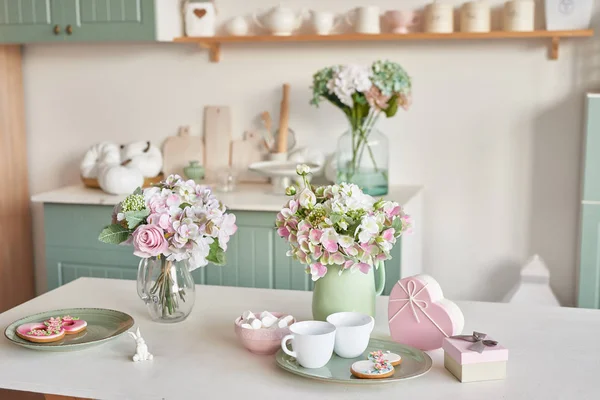 bright kitchen in the style of Provence, on the table dishes and a bouquet of flowers in a vase