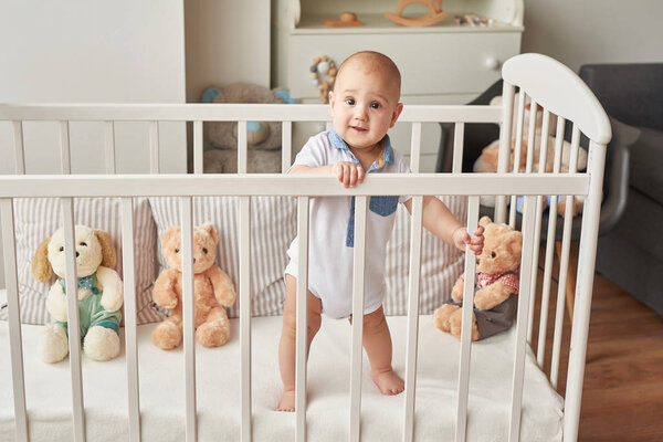 boy in a bed with toys in the children's room