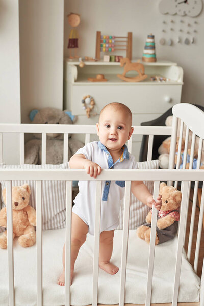boy in a bed with toys in the children's room