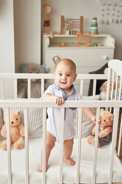 boy in a bed with toys in the children's room