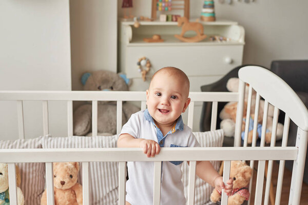 boy in a bed with toys in the children's room