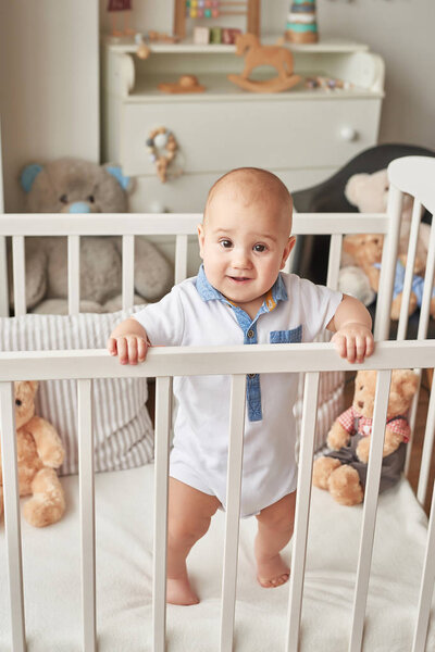 boy in a bed with toys in the children's room