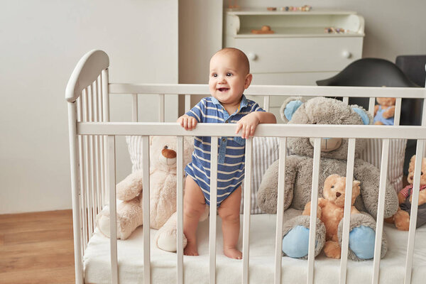 boy in a bed with toys in the children's room