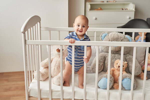 boy in a bed with toys in the children's room