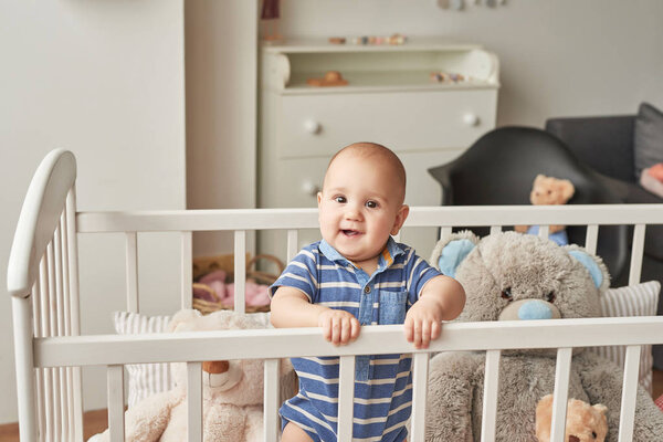 boy in a bed with toys in the children's room