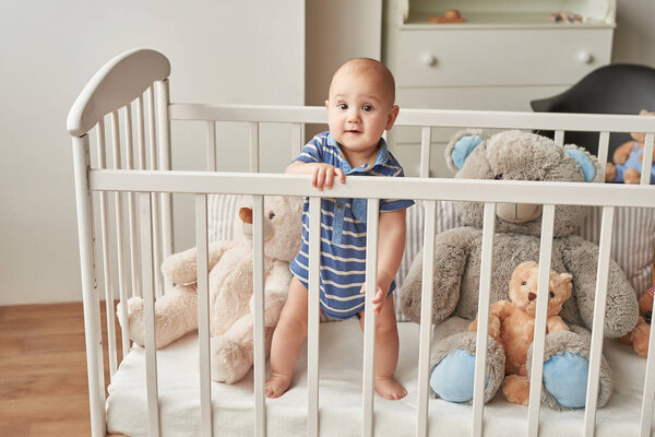 boy in a bed with toys in the children's room