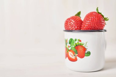 beyaz bir arka planda bir fincan çilek