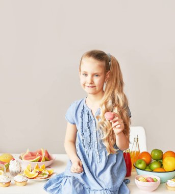 The girl eats fruit pineapple, watermelon, apples and drinks drinks from chia. Healthy food in the children's menu