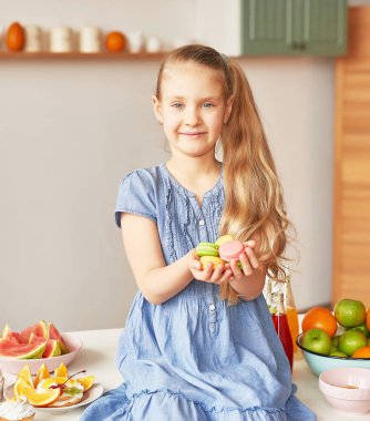 The girl eats fruit pineapple, watermelon, apples and drinks drinks from chia. Healthy food in the children's menu