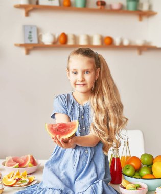 The girl eats fruit pineapple, watermelon, apples and drinks drinks from chia. Healthy food in the children's menu