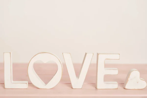 wedding decor letters love on a light background, near the heart