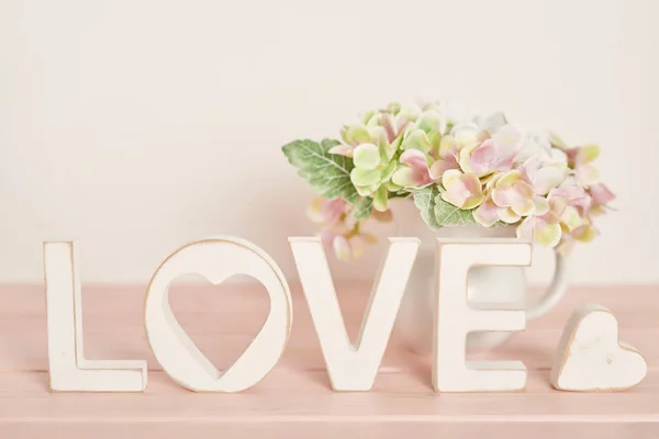 wedding decor letters love on a light background, near the heart