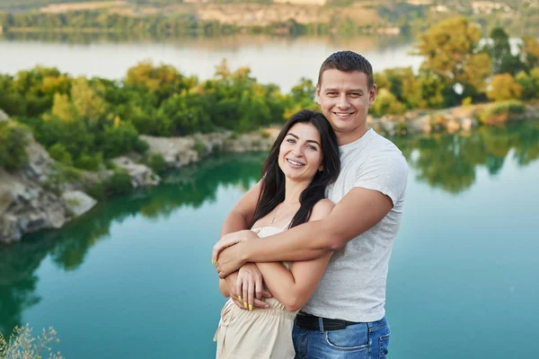 young couple on the nature near the lake resting at sunset