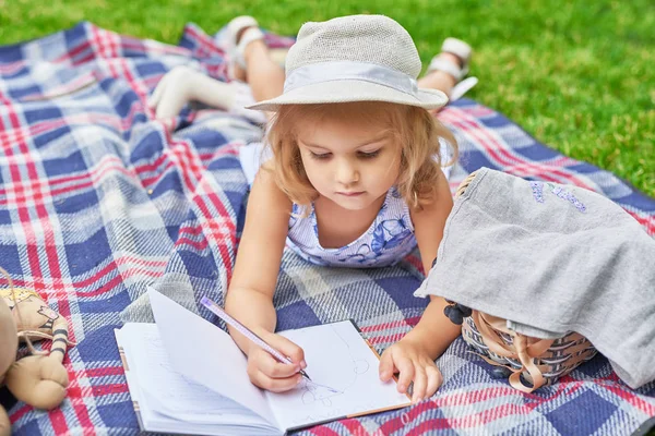 girl with a book in the park on a picnic