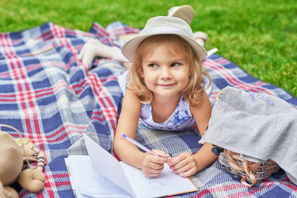 girl with a book in the park on a picnic