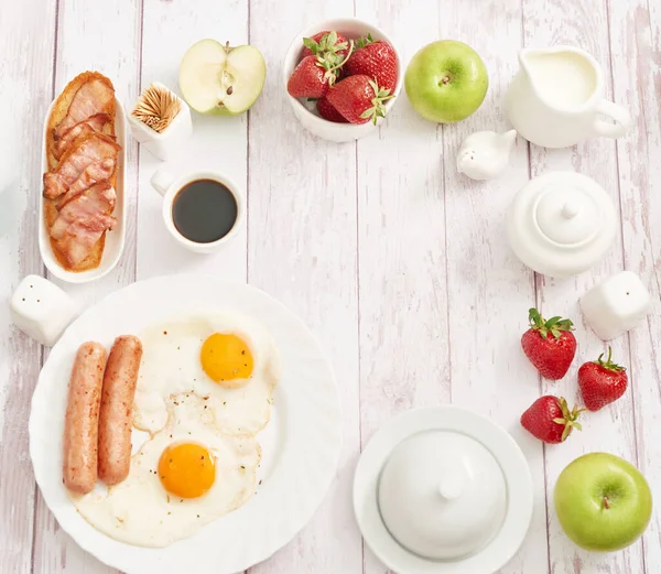 Healthly food. Continental breakfast in hotel room or bed. Fried eggs with sausages. Cup of coffee. Menu template. Cookery. Cooking. Romantic french or rural breakfast on Valentine