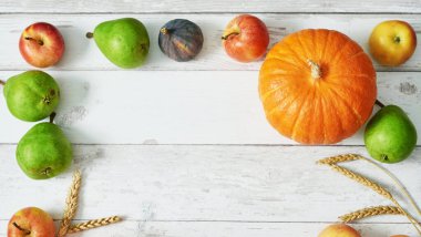 Sonbahar hasat balkabağı arka planı. Sonbahar hasadı sebze ve meyve. Balkabakları, elmalar, armutlar, masada mısır. Şükran Günü masası. Cadılar Bayramı ya da mevsimsel sonbahar. Tebrik kartı. Sonbahar mutfağı