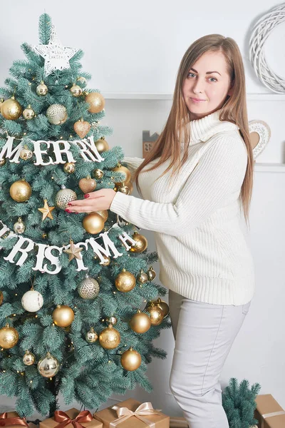 Woman near Christmas tree background. Luxury New Year. Merry Christmas background with girl. Christmastime celebration. Winter Holidays. Xmas mock up