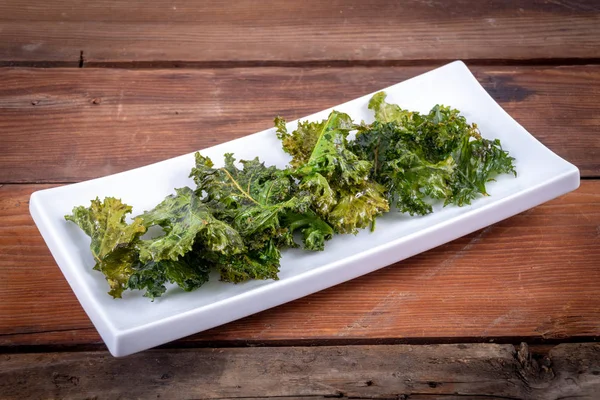 Oven baked olive oil and salt kale chips — Stock Photo, Image