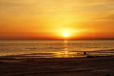 Denizin üzerinde güzel bir gün batımı. Güneş suyun üzerinde batar. 
