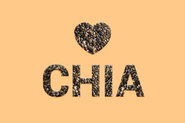 Pastel arka plan üzerinde kalp ile Chia tohumları doku metin. Şeftali renk arka plan üzerinde süper gıdalar. Tüm tahıl ham organik tohum tipografi. Süper Gıda ve detoks gıda.