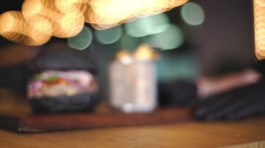 Burger and fries. Meat burger with black bun. Serving a burger in a restaurant. Black burger. 