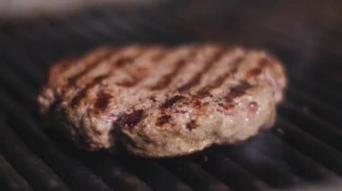 Burger pirzolası. Hamburger için pirzola pişirme işlemi. Şef restoranın mutfağında bir burger pişiriyor. Burger pirzolası kızarıyor.. 