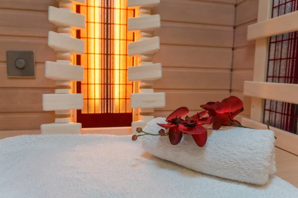 Private infrared sauna with towel and flower