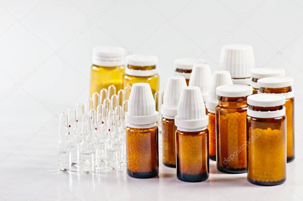 Homeopathic medicines isolated on white
