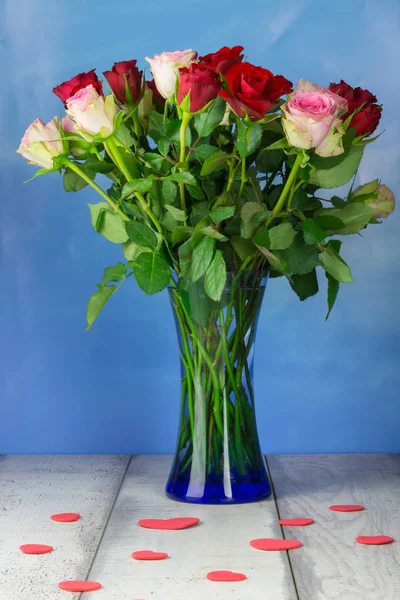 Bouquet Roses Glass Vase Blue Background Red Hearts Wooden Table — Stock Photo, Image