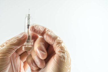 Hand with syringe, white background with copy space