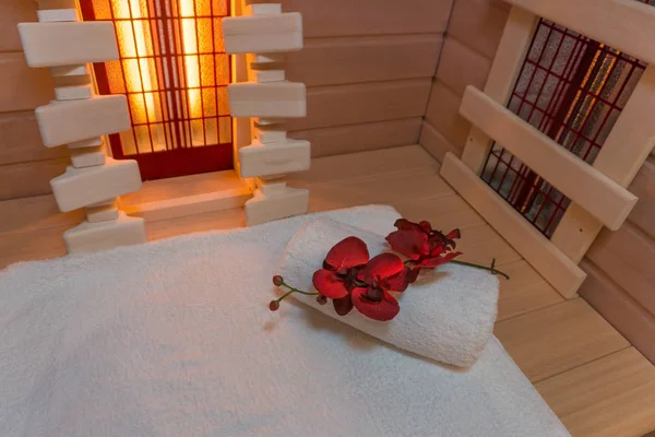 Privat indoor infrared sauna with towel and flower