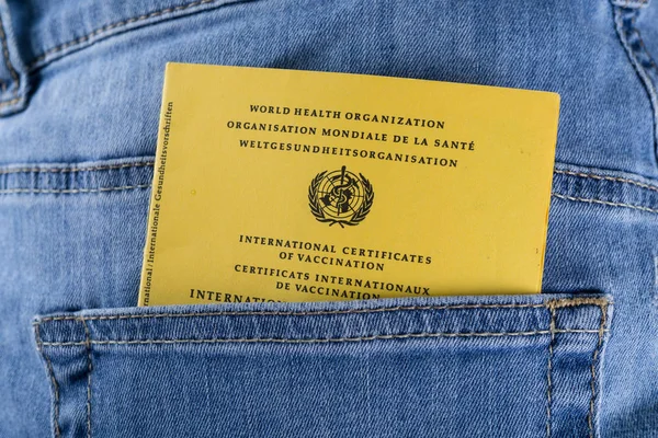 International certificates of vaccination in the pocket of a jeans